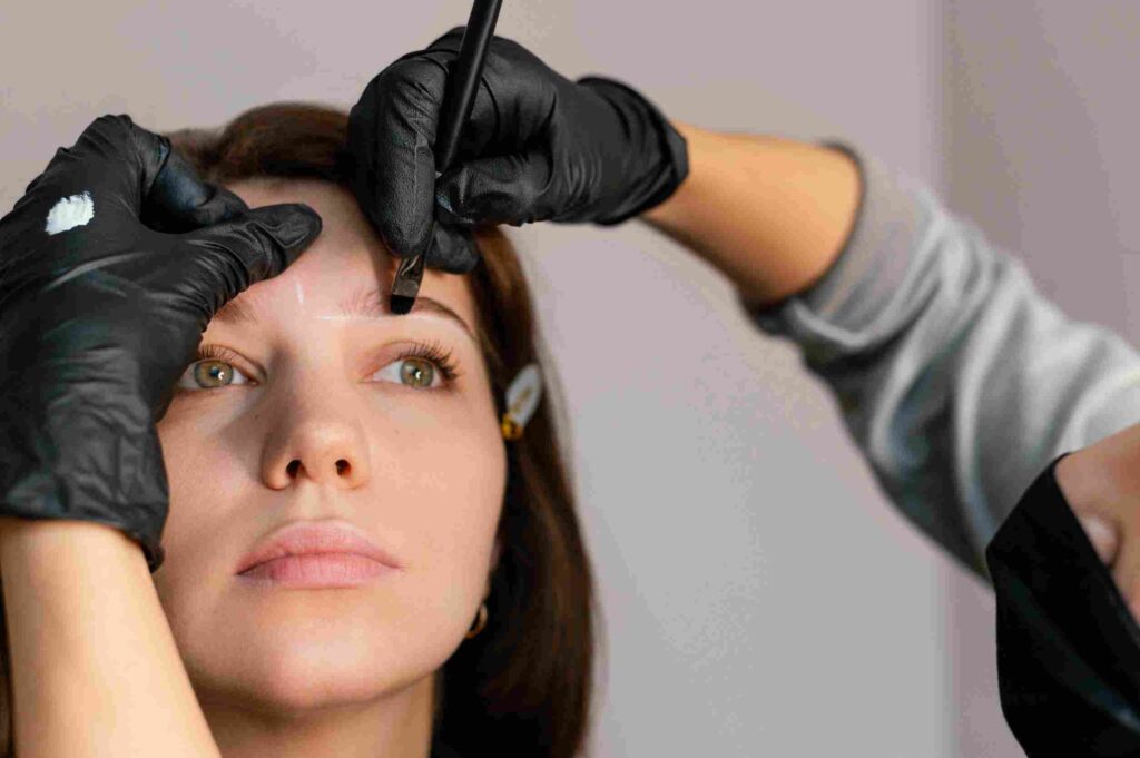 front-view-woman-getting-eyebrow-treatment-from-beautician_11zon